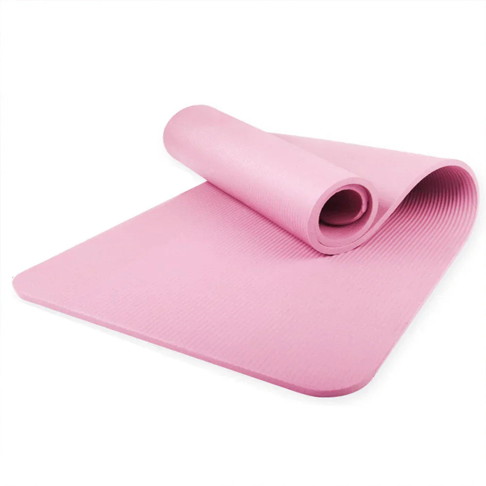 Pink non-slip yoga mat with textured surface for stability and thick cushioning for comfort