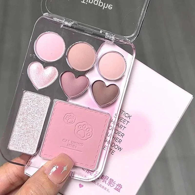 8-color pink orange eyeshadow palette with heart-shaped blushers and shimmery highlighter in clear compact case