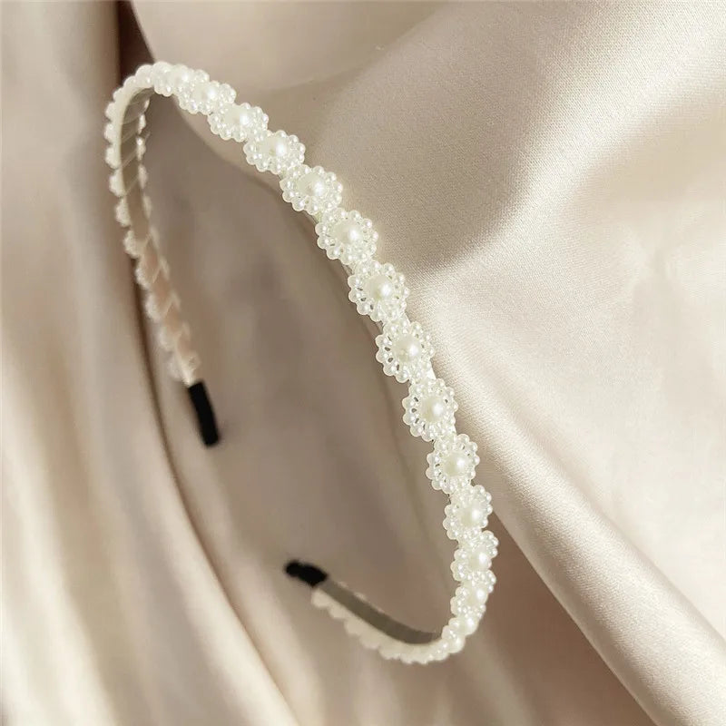 Modyle Full Pearl Hairband with elegant floral pearl design and elastic fit on satin background