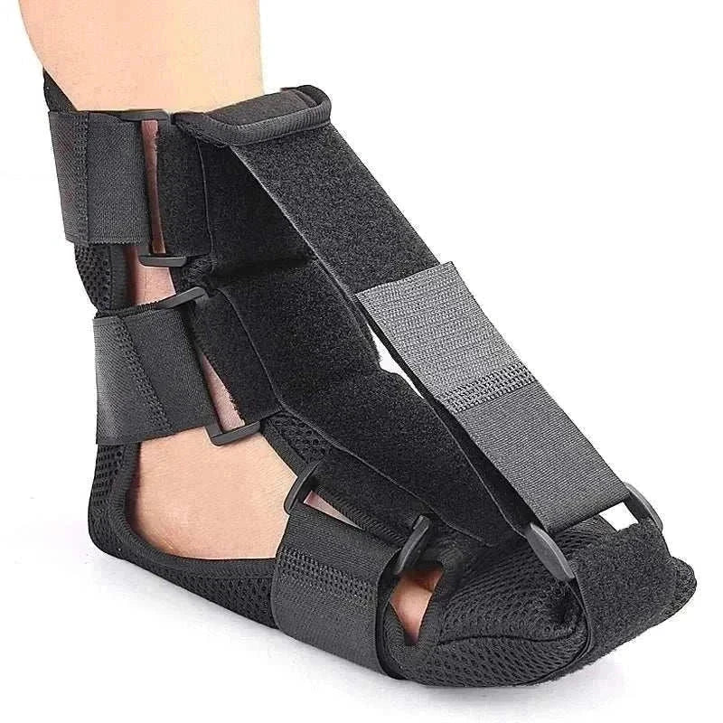 Black adjustable night splint for plantar fasciitis with breathable straps and cushioned support.