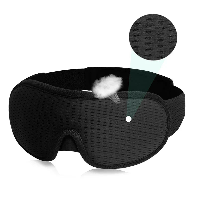 Black 3D sleeping mask with breathable fabric and adjustable strap for total light blockout and comfortable sleep.