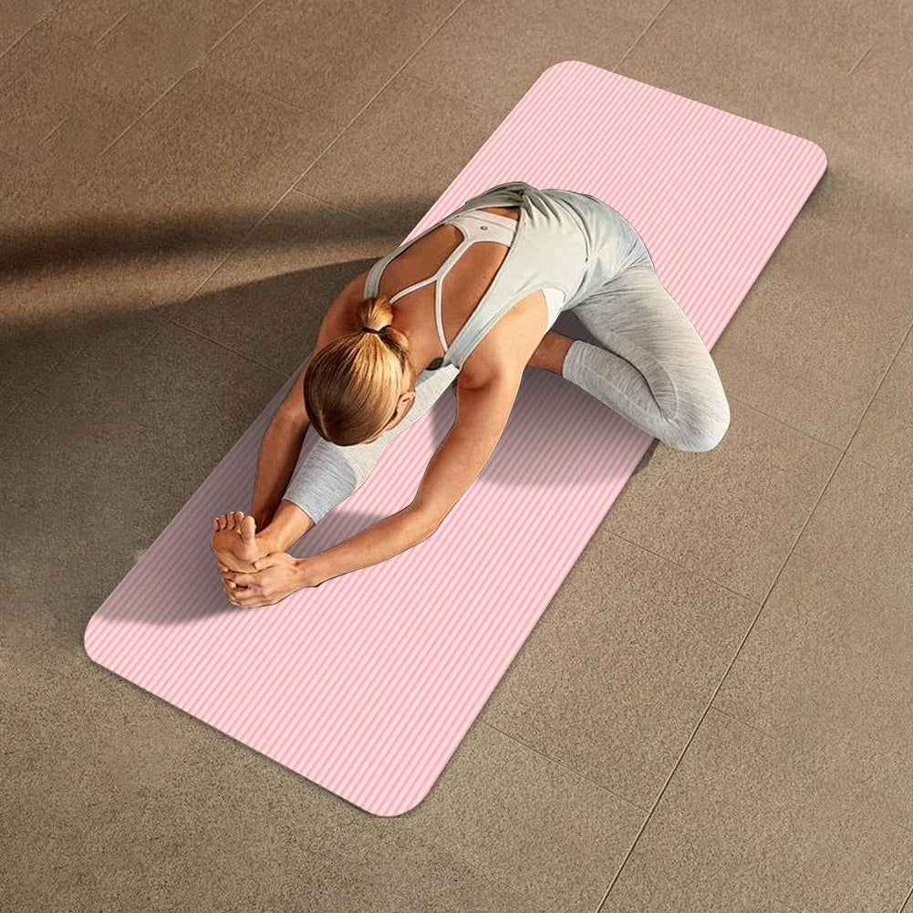 Woman stretching on pink non-slip yoga mat with textured surface and thick cushioning