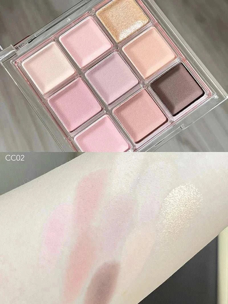 Black Pink Smoky Eye shadow palette with pearlescent and matte pink, brown, and neutral shades swatched on arm