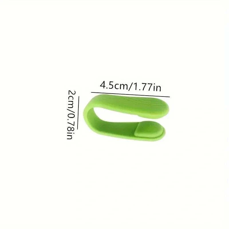Compact green Finger Joint Tiger Point Massage Clip for acupressure and improved blood circulation.