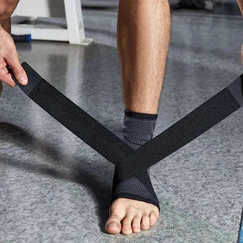 Person wrapping foot with black pressurized bandage ankle protector strap for support and compression