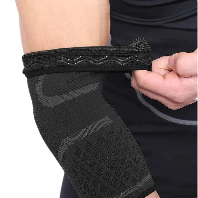 Black elastic elbow support sleeve worn on arm for joint stability and athletic use