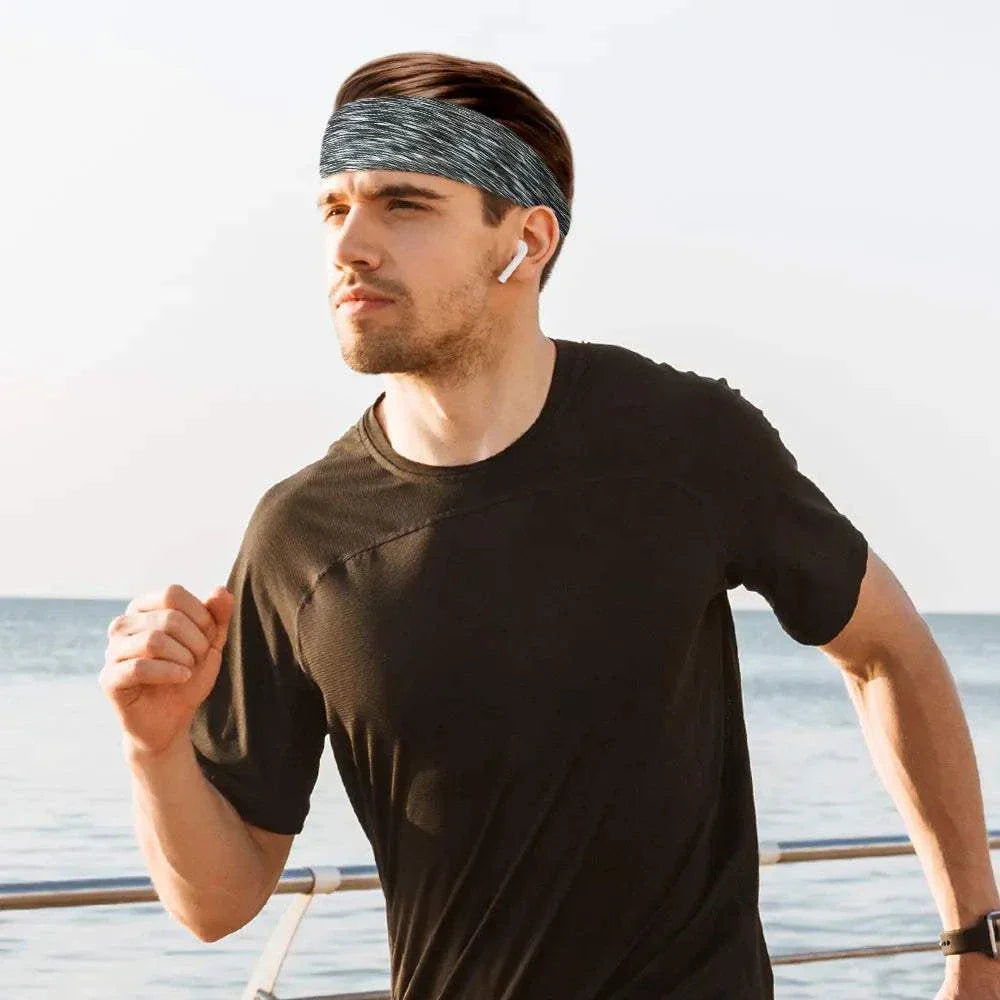 Man running outdoors wearing a grey Fashion Sweatband Sport Headband and black athletic shirt