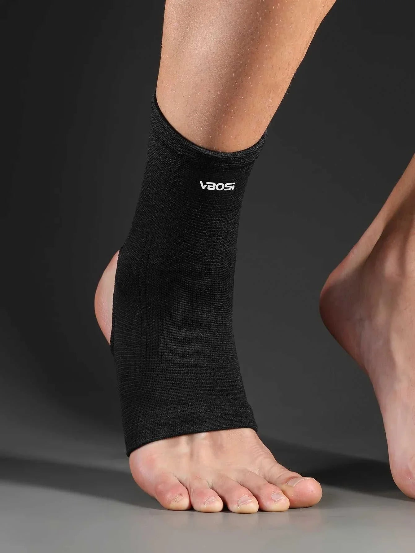 Black elastic breathable ankle support brace worn on foot for sports and daily use