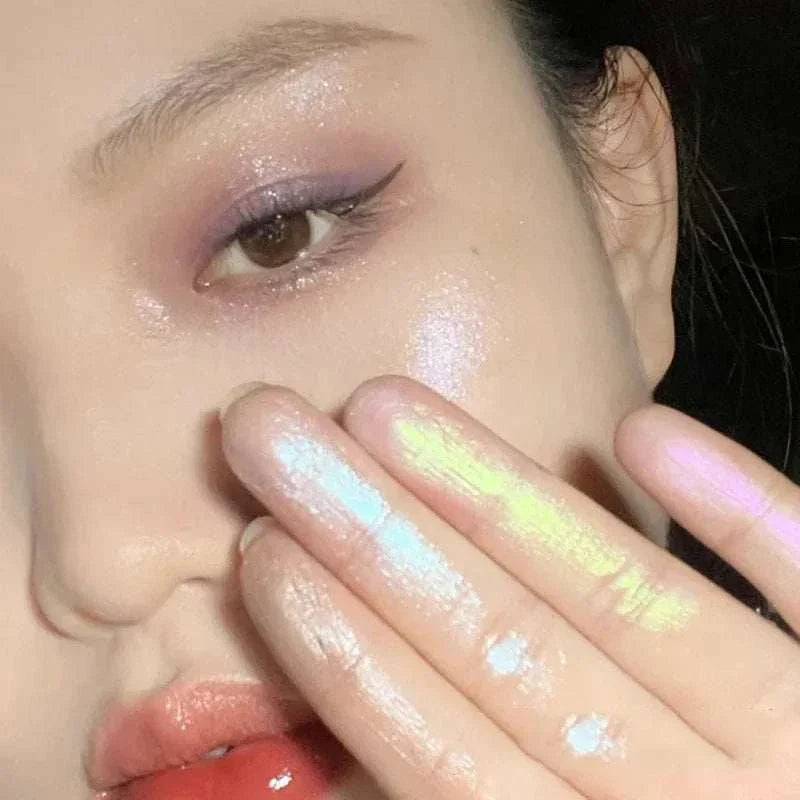 Close-up of a woman showcasing shimmering pastel shades from the Diamond Glitter Monochrome Eyeshadow Palette applied on her fingers and eyelids.