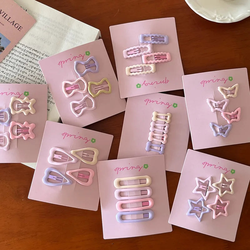 Cute colorful geometric mini hair clips set on pink cards in pastel shades