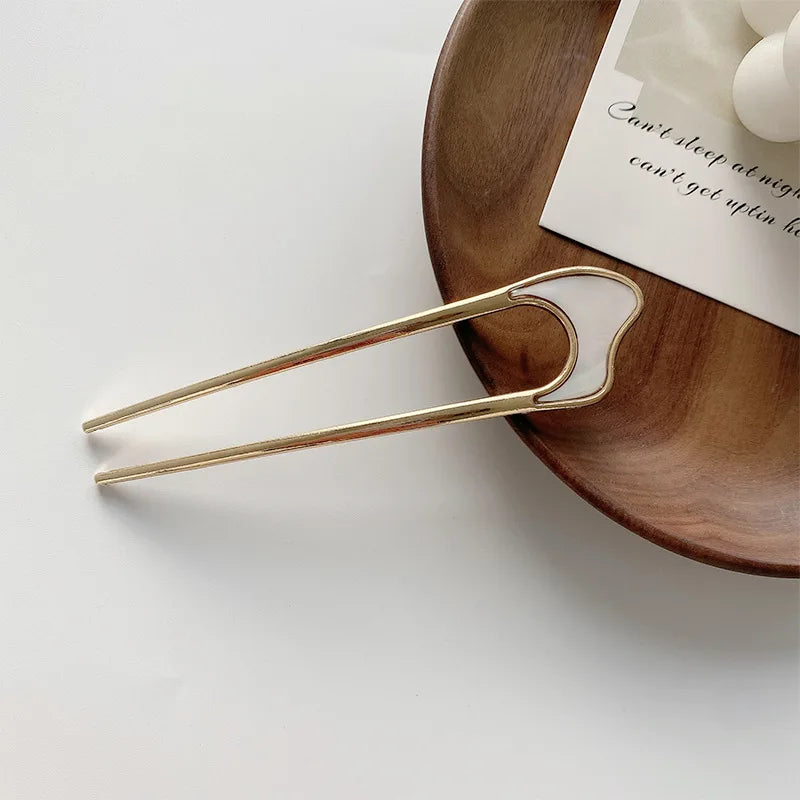 pearl u-shaped hairpins with metallic shell detail on wooden tray