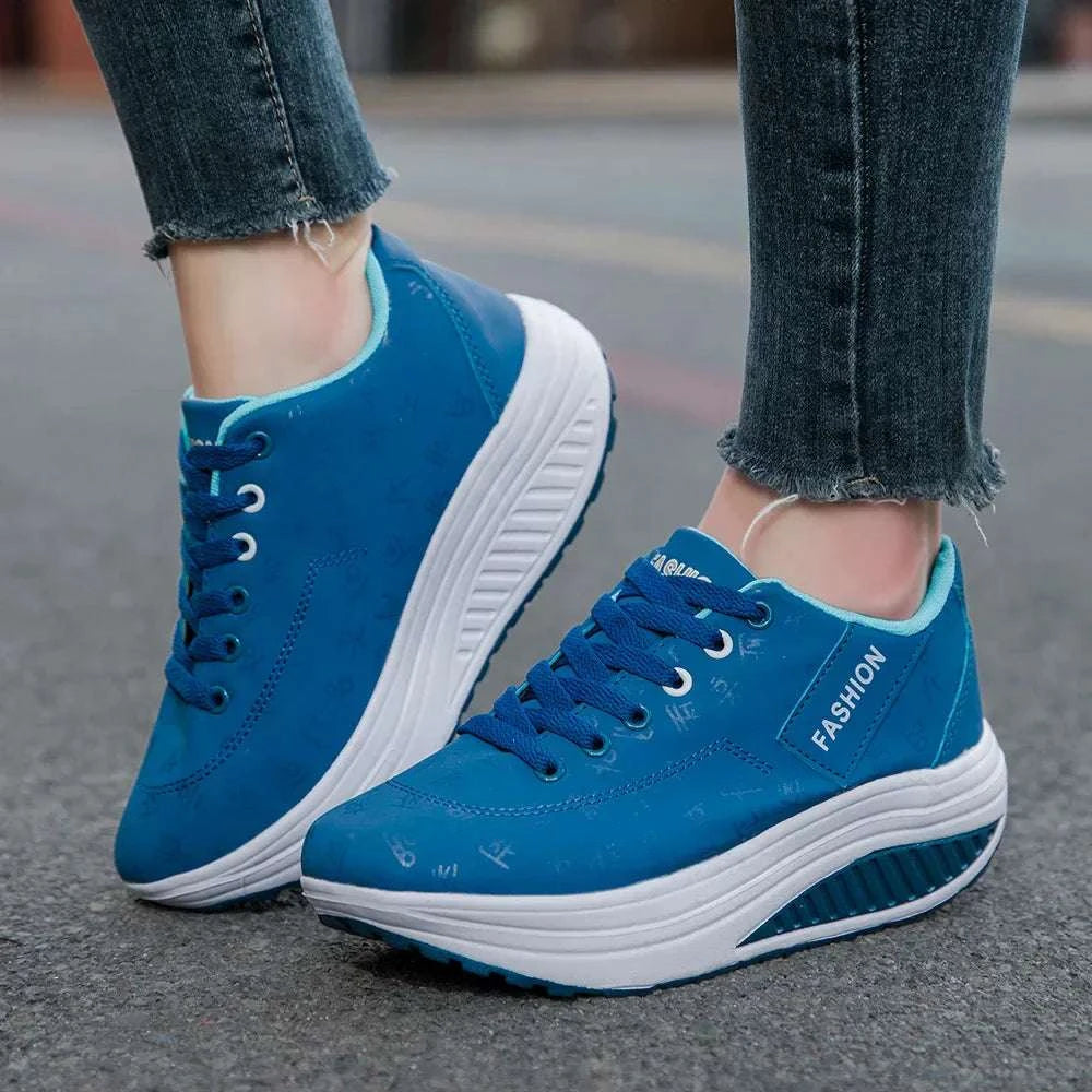 Blue breathable wedge heel sneakers with lace-up closure and thick cushioned sole for women