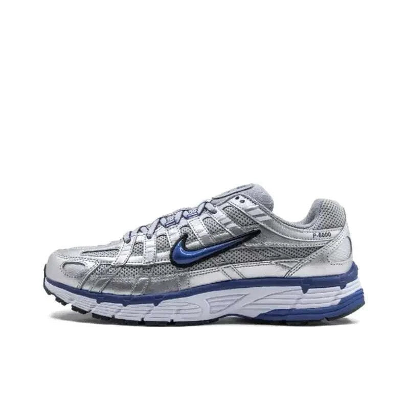 Nike P-6000 Unisex casual running sneaker in black, metallic silver, and white with breathable mesh upper and cushioned midsole.