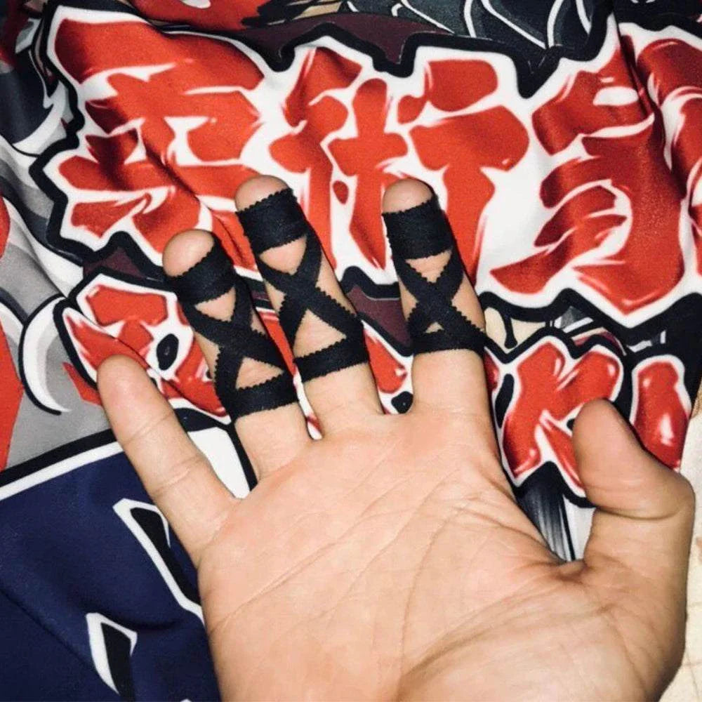 Hand with three fingers wrapped in black elastic Jiu-Jitsu bandage tape on a colorful martial arts-themed background