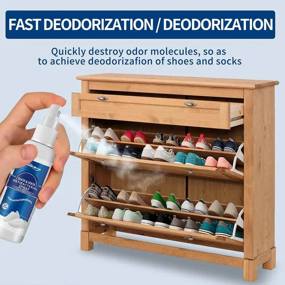 Hand spraying 60ml antibacterial shoe and foot odor spray on a wooden shoe rack filled with various shoes for fast deodorization of shoes and socks.