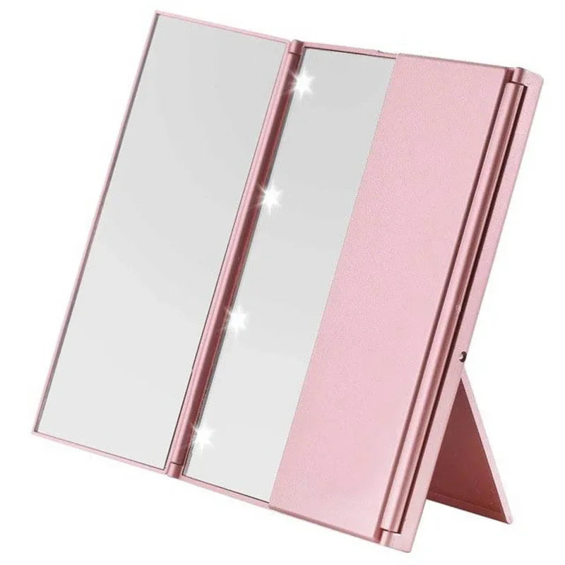 Portable three-sided LED makeup mirror with bright LED lighting and adjustable angles in a sleek pink compact design for travel and precise beauty application