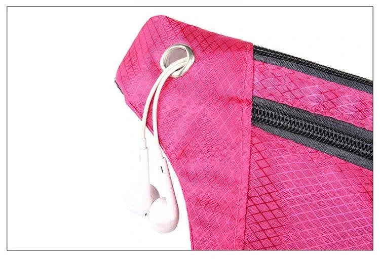 Pink nylon waist and chest bag with zippered compartments and earphones hole for hands-free convenience
