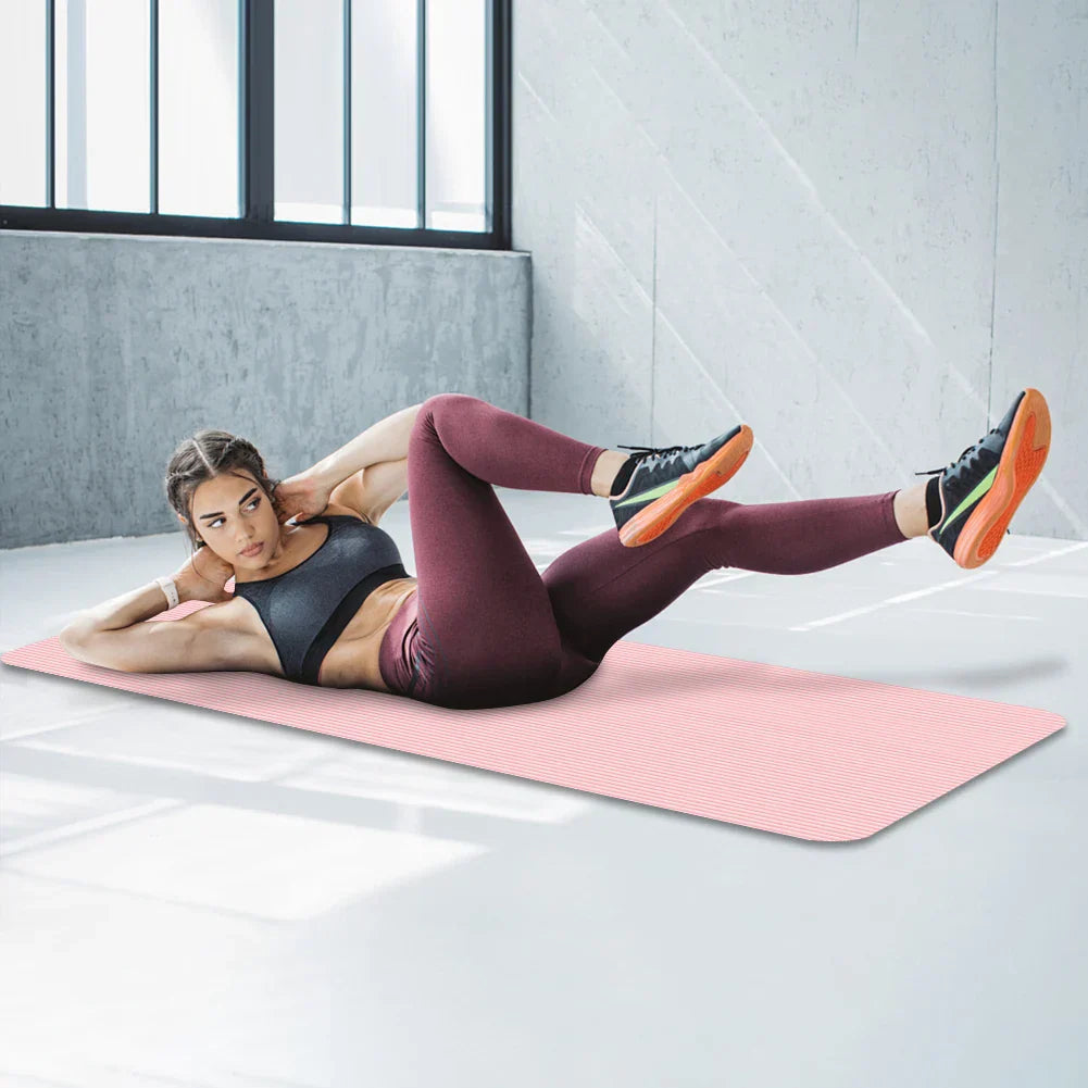 Woman exercising on a pink non-slip yoga mat in a bright room