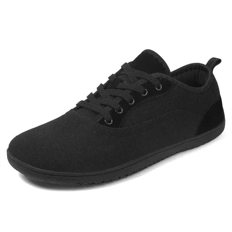 Black new hiking shoe with breathable, lightweight fabric and durable traction sole designed for barefoot comfort and wide fit