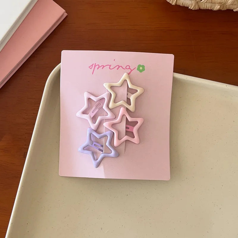 Set of 4 cute colorful geometric star-shaped mini hair clips for girls on pink card