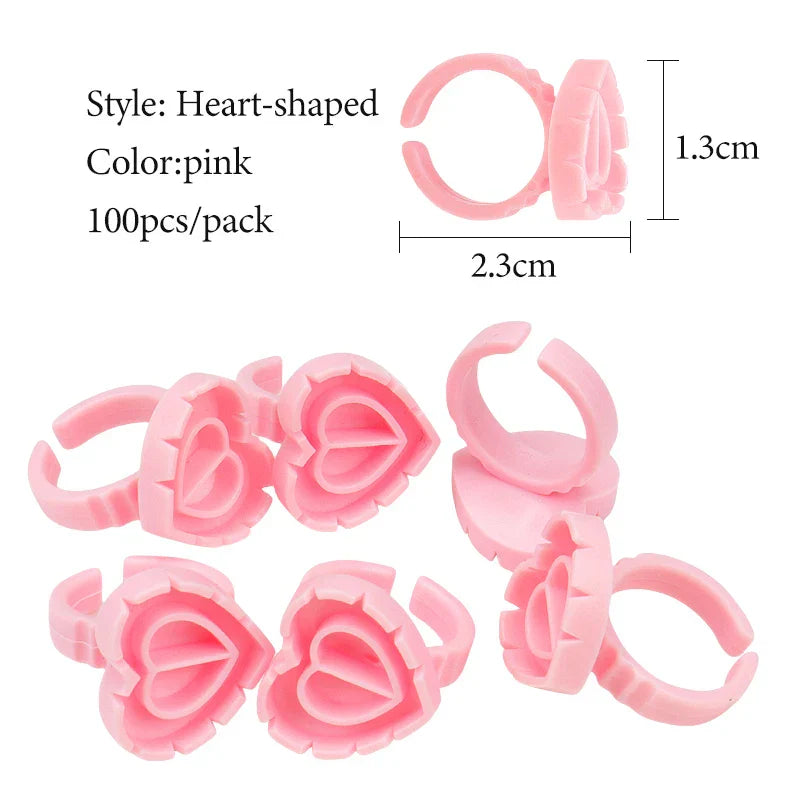 Pink heart-shaped disposable glue ring cups for lash extensions and tattoo pigments, pack of 100