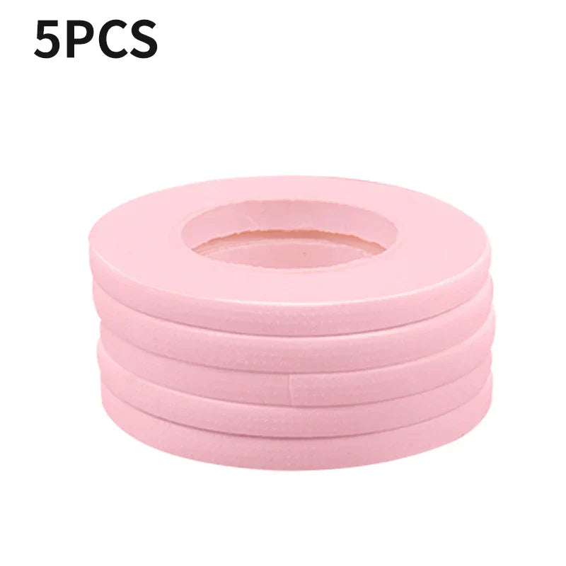 Stack of 5 pink micropore eyelash extension tapes for gentle, breathable lash application