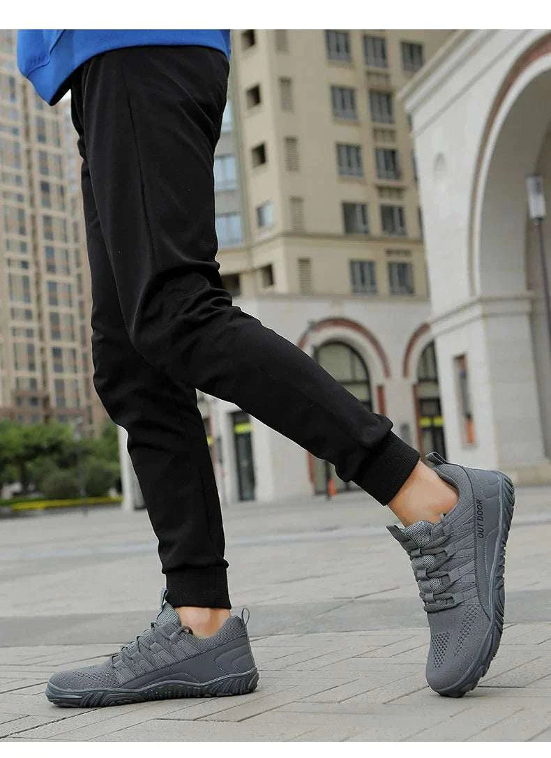 Lightweight gray new hiking shoes with durable traction sole worn outdoors on pavement