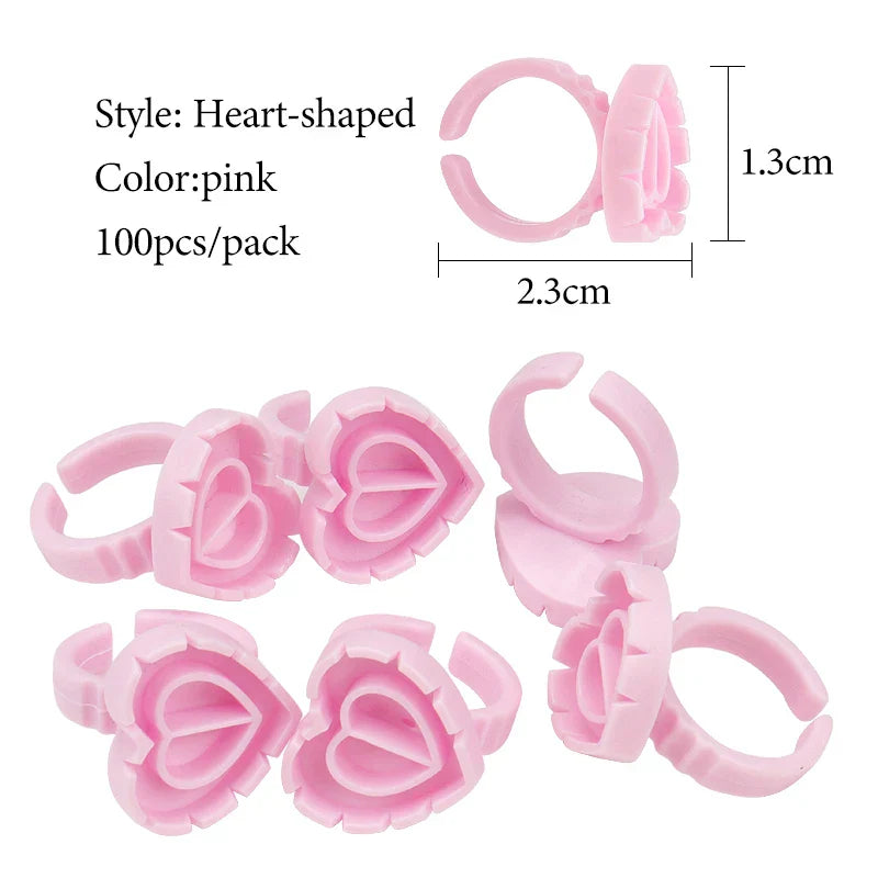Pink heart-shaped disposable glue ring cups for lash extensions and tattoo pigments, pack of 100