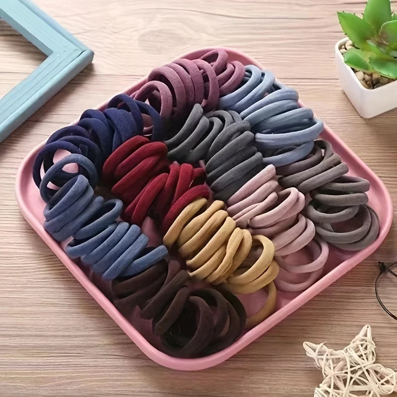 50PCS Candy Color Nylon Scrunchie Set in assorted soft pastel shades on a pink tray