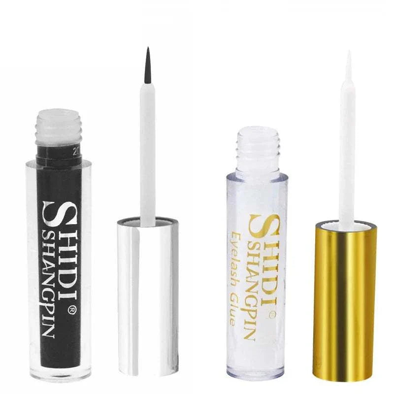 Two open tubes of SHIDI Shangpin eyelash glue with white applicators, one with black packaging and silver cap, the other with clear packaging and gold cap