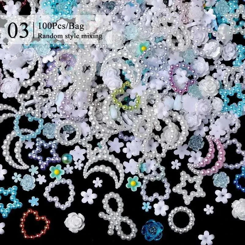 Various colorful rhinestones and nail art decorations including pearls, flowers, stars, moons, and hearts for nail design accessories
