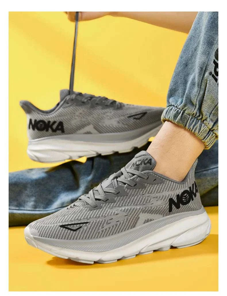 Gray Carbon Plate Air Cushion running shoes with breathable mesh upper and cushioned white sole worn with casual jeans