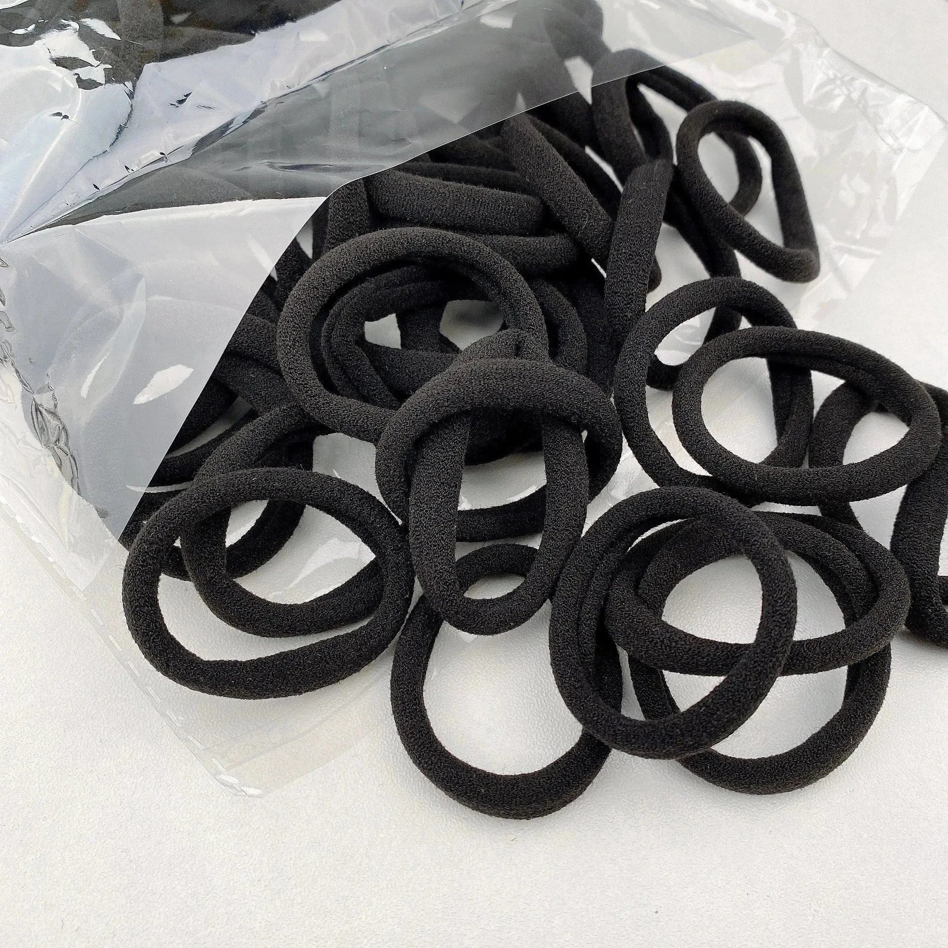 Black nylon scrunchie hair ties from candy color nylon scrunchie set in clear packaging