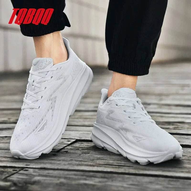 White unisex Carbon Plate Air Cushion running shoes with breathable mesh upper and durable outsole on wooden floor
