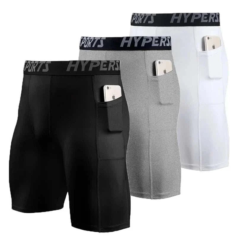 Set of three men's compression shorts in black, gray, and white with side pockets and elastic waistbands designed for athletic performance and breathability