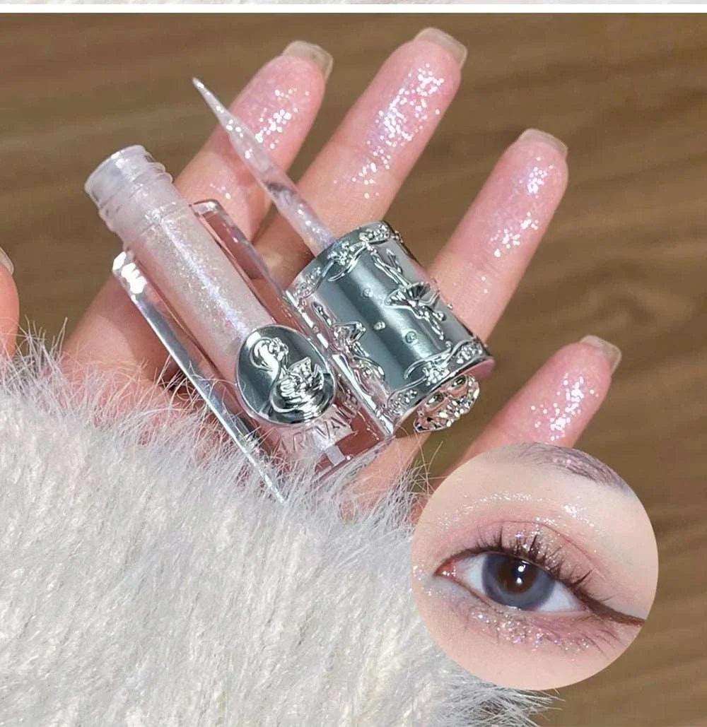 Balletism Liquid Eyeshadow with fine shimmer, delicate glitter texture in a silver decorative tube, highlighting eyelid and fingers with sparkly glow