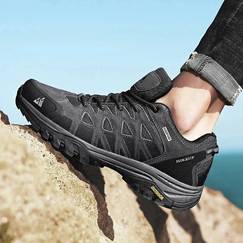 Black HIKEUP men's hiking shoe climbing rocky terrain with durable construction and superior grip soles