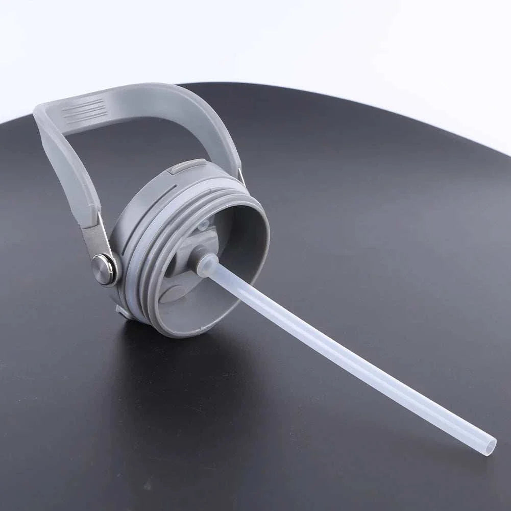 Gray vacuum insulated cup lid with handle and built-in straw on black surface