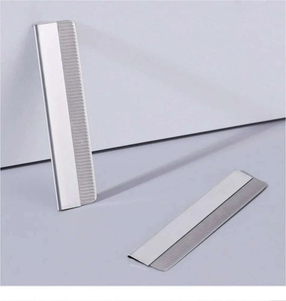 Metal precision eyebrow trimmer blades from an eyebrow pencil and trimmer set for grooming and shaping brows.