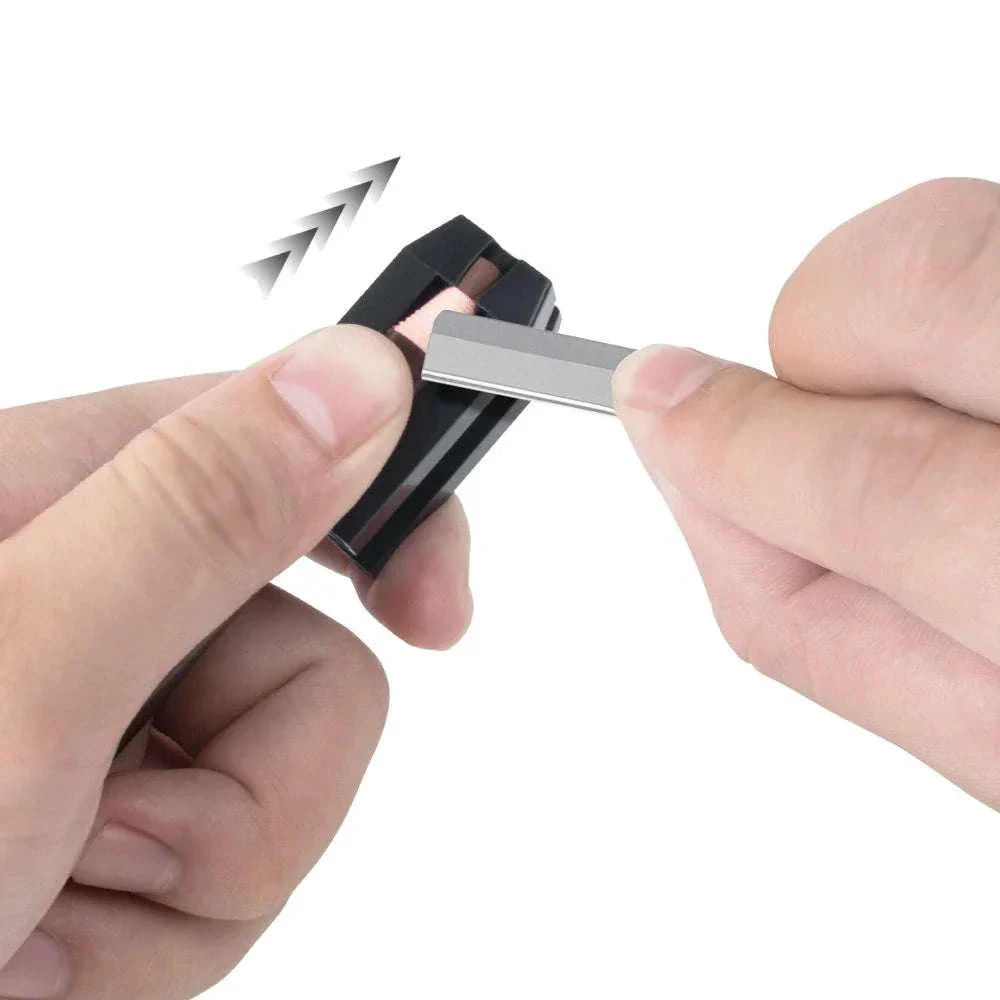 Hand using a sharpener on eyebrow pencil from the Eyebrow Pencil & Trimmer Set grooming kit