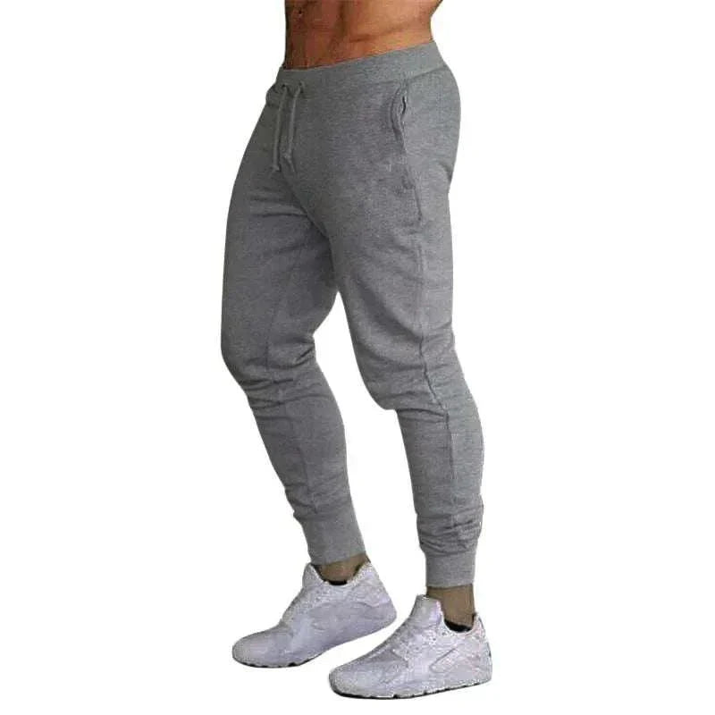 Men's training jogger sweatpants in gray with tapered fit and elastic waistband, designed for workout and casual wear
