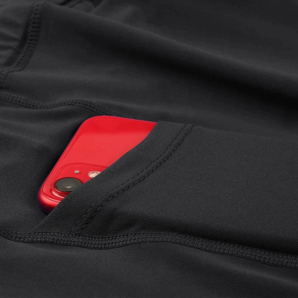 Close-up of black men's outdoor running shorts with red phone in side pocket showing breathable fabric and secure stitching