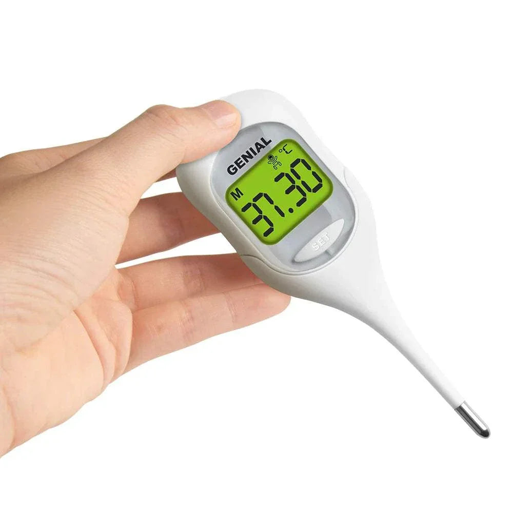 Hand holding 8-second digital oral thermometer with green LCD display showing temperature reading of 37.3°C