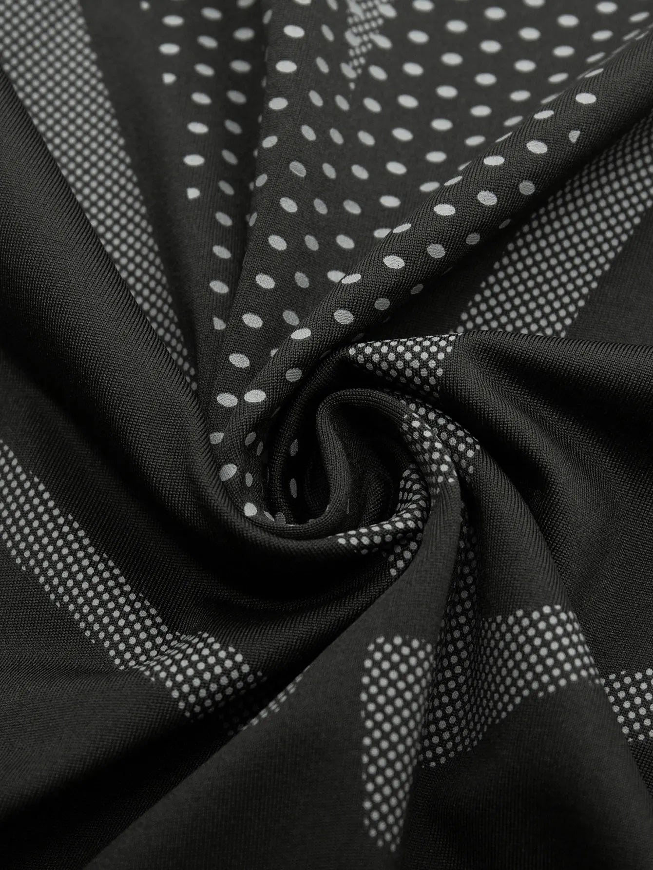 Close-up of black men's sports vest fabric with breathable, quick-dry moisture-wicking dots pattern