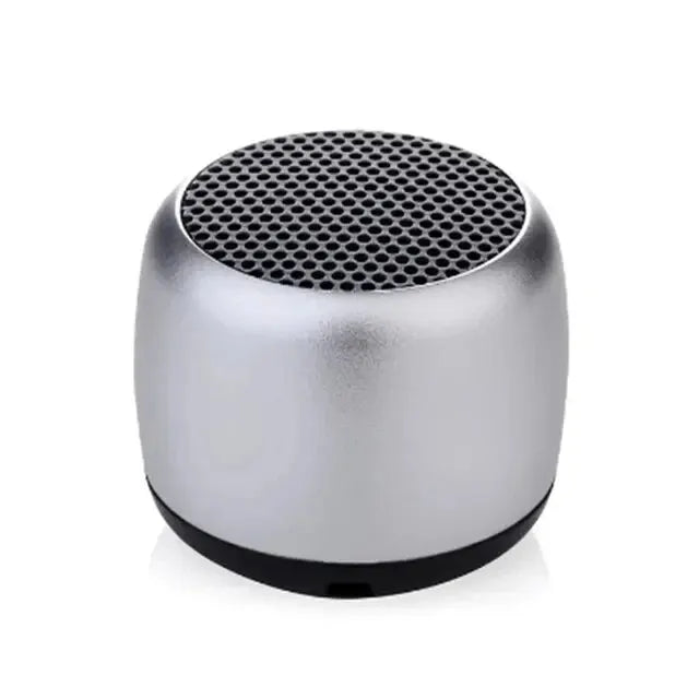 Compact silver M1 Portable Bluetooth Speaker with black mesh grille, featuring 360° stereo sound and portable design.