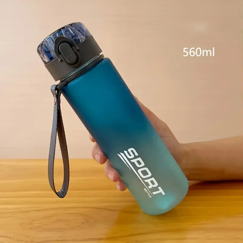 BPA-Free leak-proof sports water bottle in blue gradient, 560ml, with secure flip-top lid and carry strap for outdoor and fitness use.