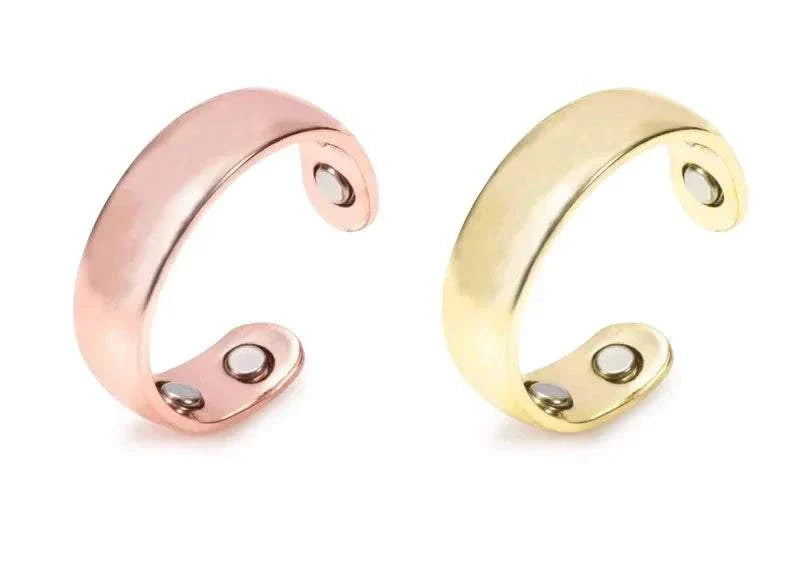 Two magnetic therapy anti snoring device rings in rose gold and gold with built-in bio-magnets for acupressure sleep aid.