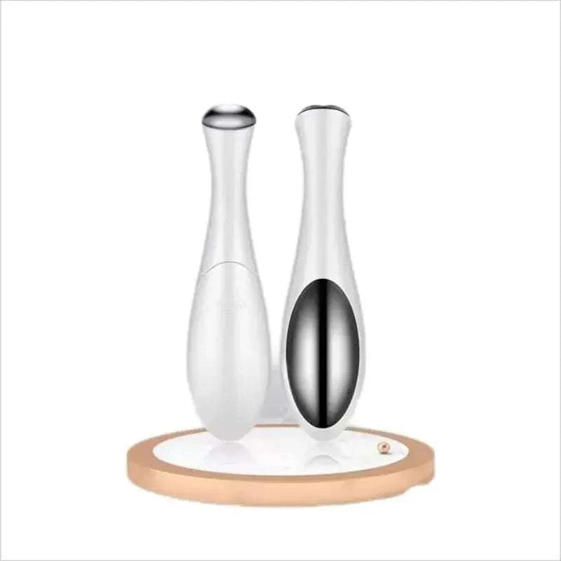 Home electric eye massage device for reducing puffiness, fine lines, and dark circles with USB rechargeable compact design.