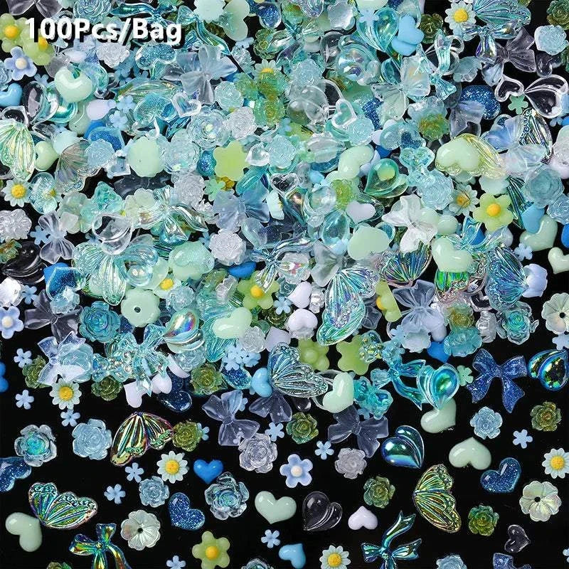 assorted blue and green rhinestones and 3D nail art decorations on black background, perfect for use with BORN PRETTY 10g Gel Nail Glue