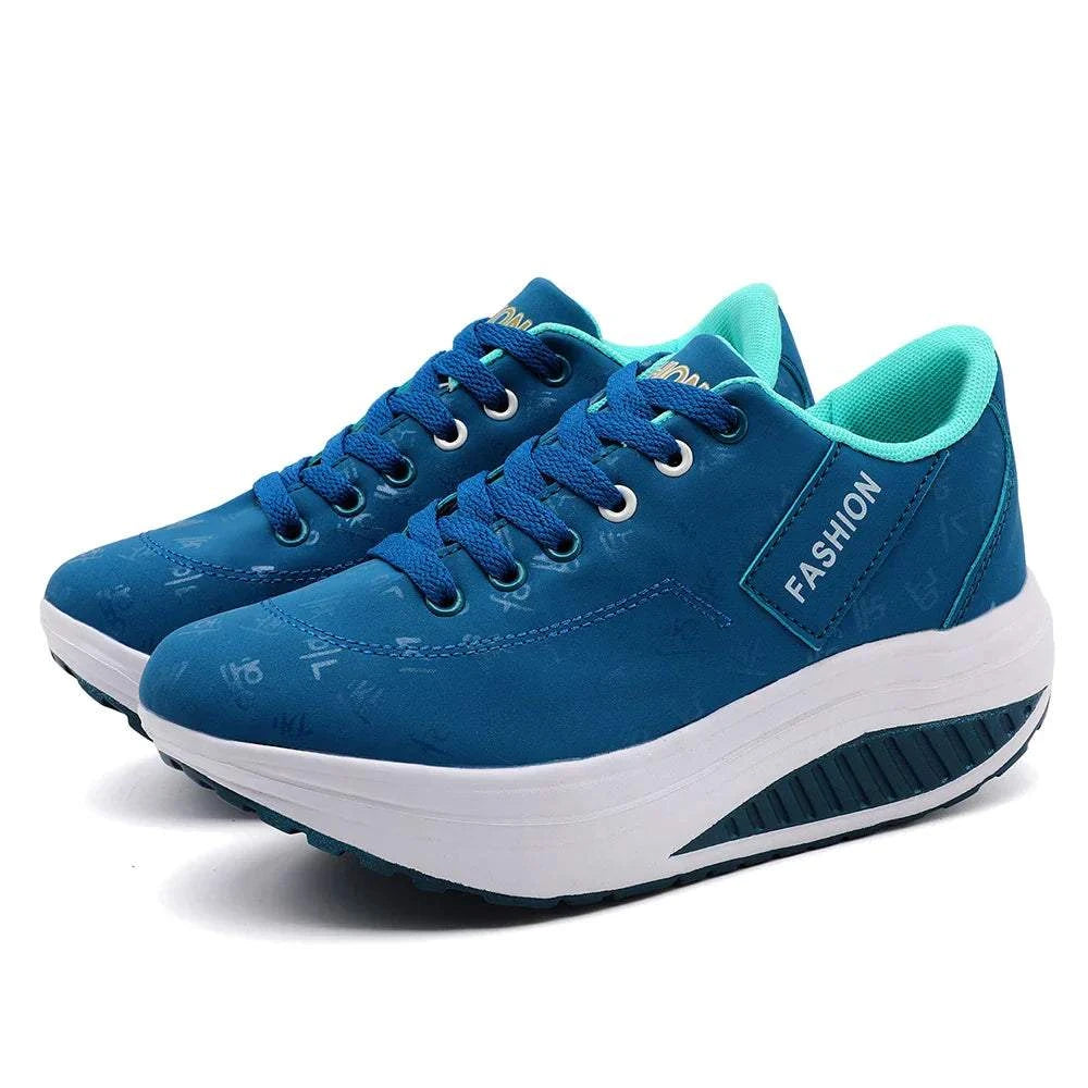 Blue breathable wedge heel sneakers with lace-up closure and cushioned sole for women